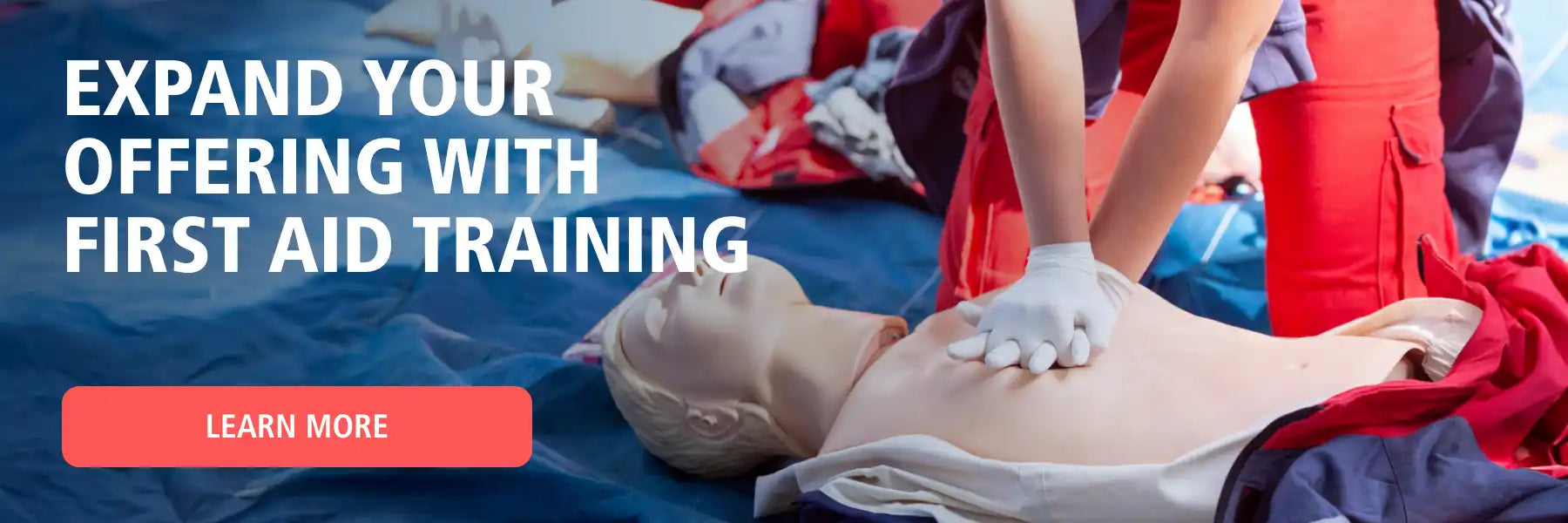 CPR training manikin with a person demonstrating chest compressions.