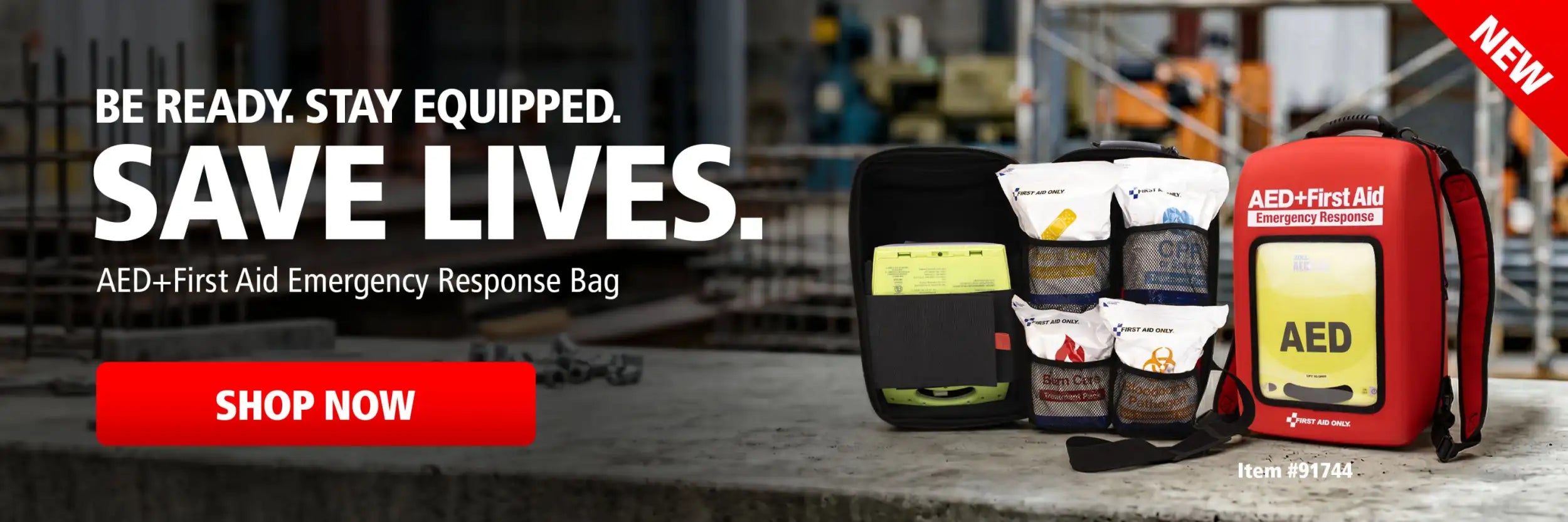 Red aed+first aid emergency response bag with yellow label and black straps.